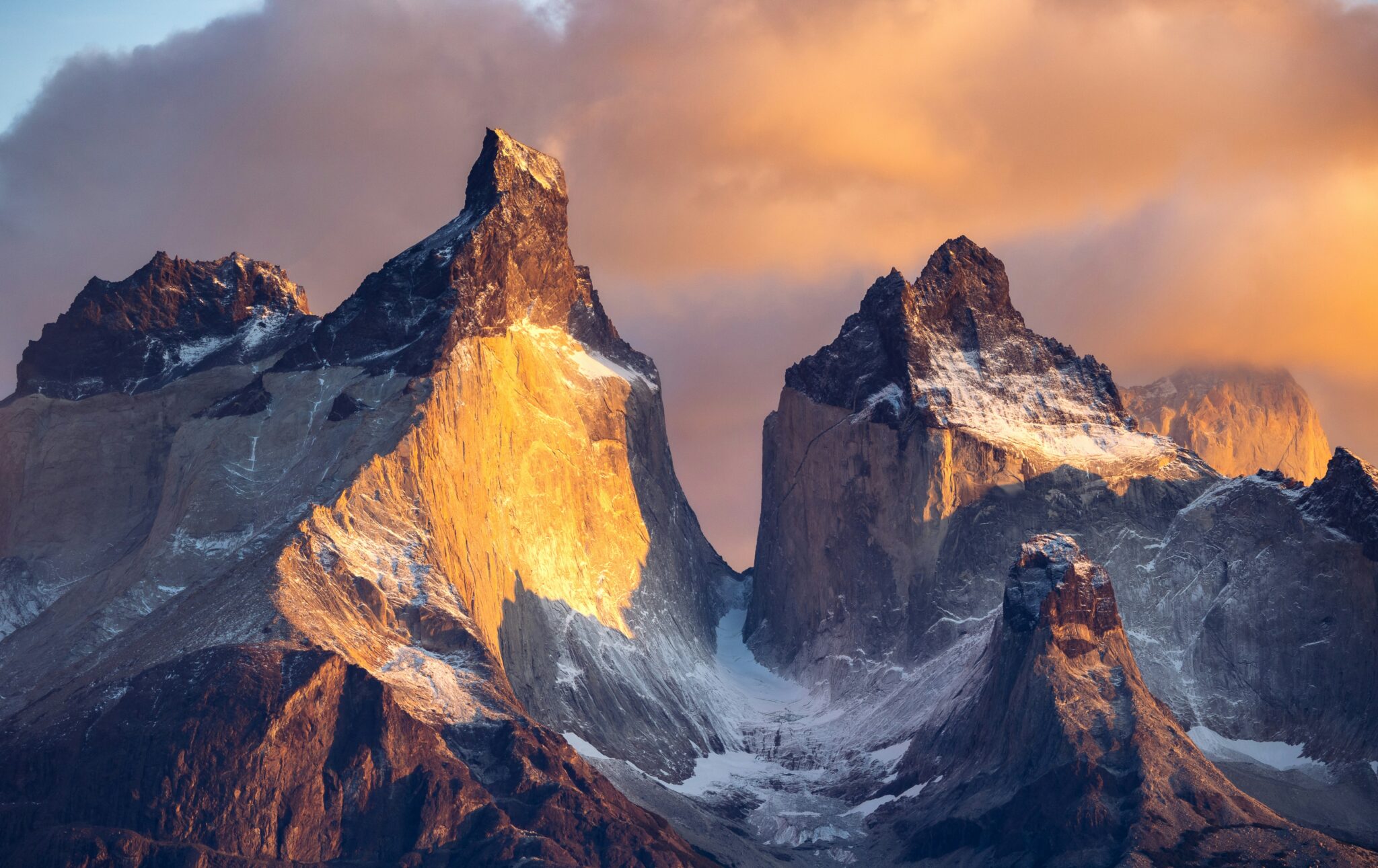 A mountain range with snow on it's sides.